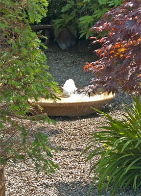 Small bowl water feature brings low tones and a peaceful atmosphere to the garden