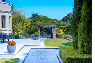 Large country garden, including a terrace and formal water feature
